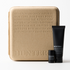 Skincare product set with a beige box and black bottles on a white background